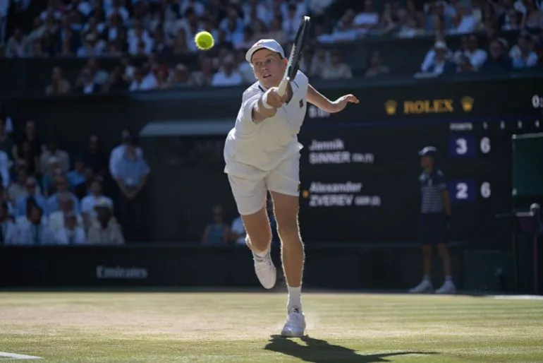 Jannik Sinner of Italy plays a backhand against Alexander Zverev of Germany during their Gentlemen's Singles final match on day fourteen of The Championships Wimbledon 2026 at All England Lawn Tennis and Croquet Club