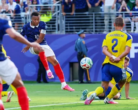 France's Kylian Mbappe scores their first goal.